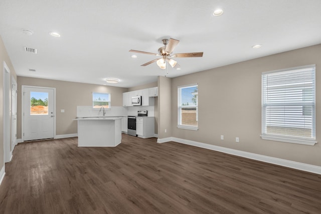 kitchen featuring appliances with stainless steel finishes, ceiling fan, sink, dark hardwood / wood-style floors, and white cabinetry