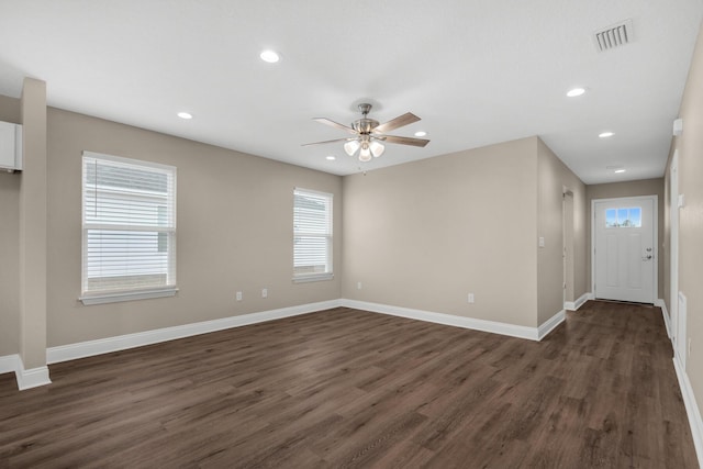 spare room with dark hardwood / wood-style floors and ceiling fan