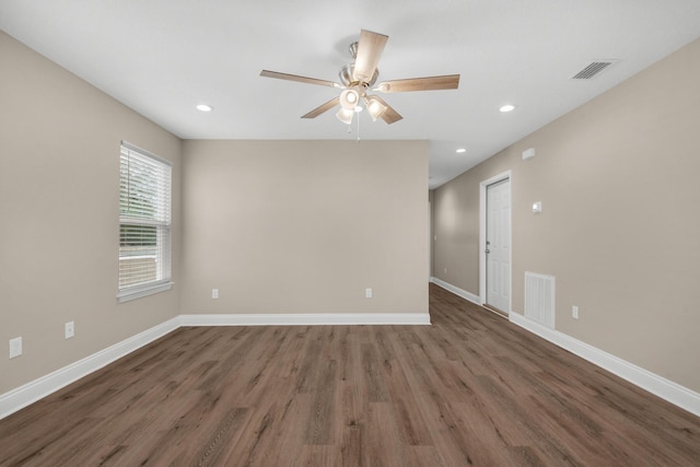 spare room with ceiling fan and dark hardwood / wood-style flooring