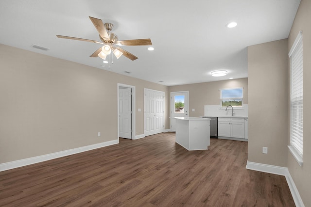 interior space with ceiling fan, sink, and dark wood-type flooring