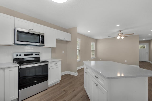 kitchen with white cabinetry, a healthy amount of sunlight, and stainless steel appliances