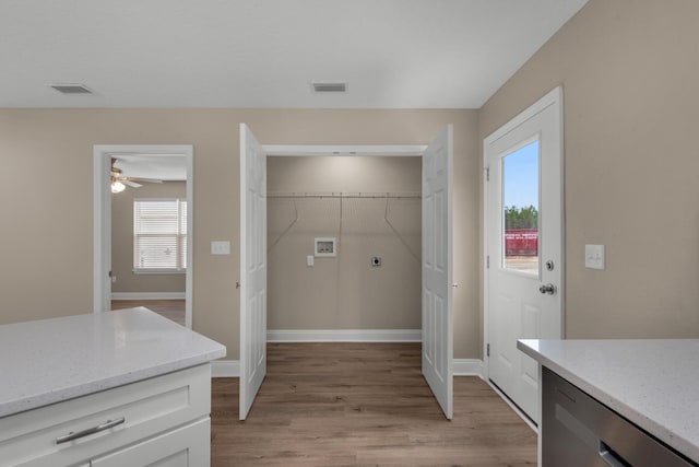 laundry area featuring hookup for an electric dryer, ceiling fan, light hardwood / wood-style floors, and washer hookup