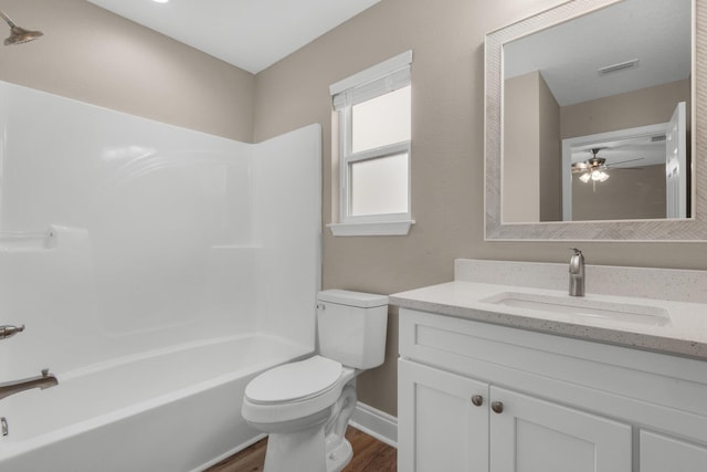 full bathroom with shower / bathtub combination, vanity, ceiling fan, wood-type flooring, and toilet