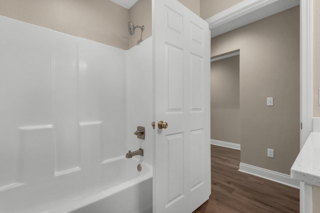 bathroom featuring bathing tub / shower combination and wood-type flooring