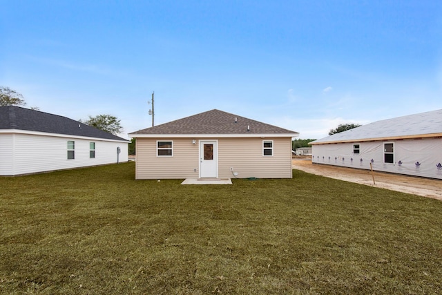 rear view of house with a lawn