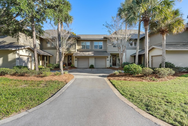 view of front of house with a front lawn and a garage