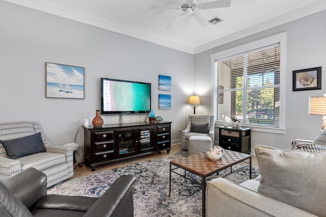 living room featuring ceiling fan and ornamental molding