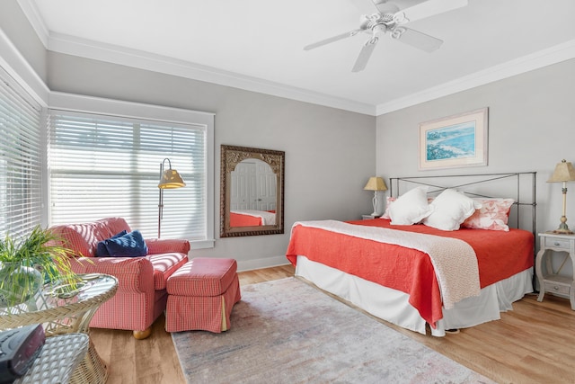 bedroom featuring light wood-type flooring, ceiling fan, and ornamental molding