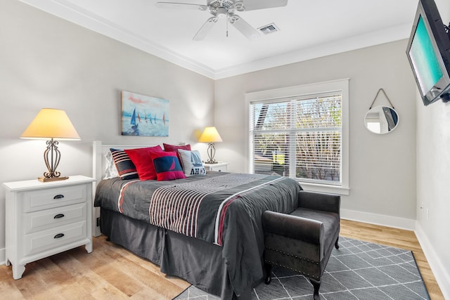 bedroom with wood-type flooring, ceiling fan, and ornamental molding