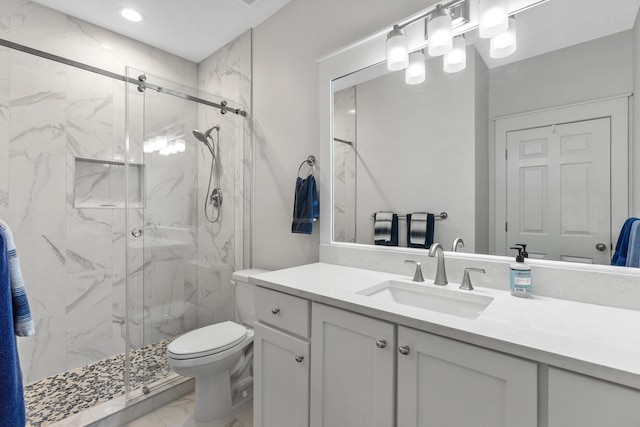 bathroom with vanity, toilet, and an enclosed shower