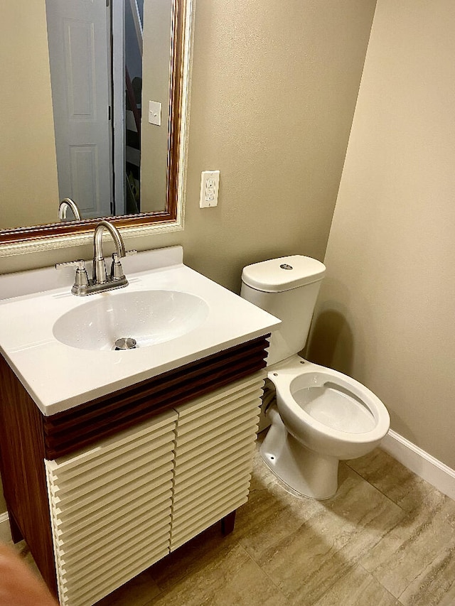 bathroom featuring toilet and vanity