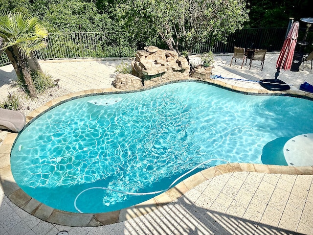 view of swimming pool featuring a patio area