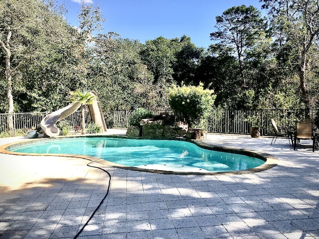 view of pool featuring a patio and a water slide