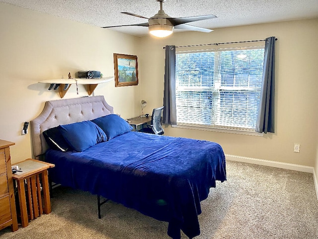 bedroom with ceiling fan, a textured ceiling, and carpet flooring