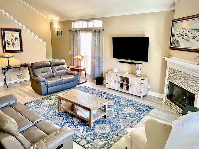 living room featuring a brick fireplace, hardwood / wood-style floors, crown molding, and a textured ceiling