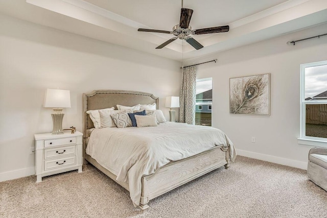 bedroom with ceiling fan, light carpet, and multiple windows