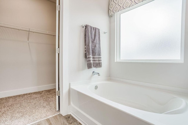 bathroom featuring hardwood / wood-style flooring and a bathtub