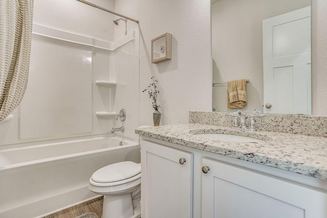 full bathroom with vanity, shower / bath combination, hardwood / wood-style flooring, and toilet