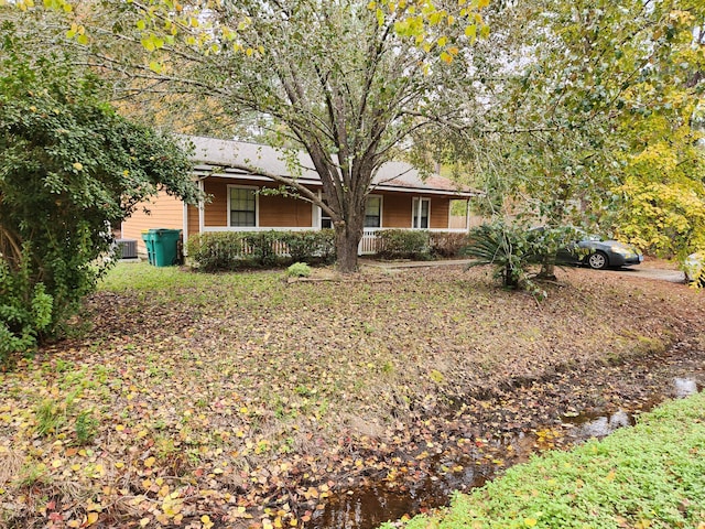 ranch-style home featuring central AC and a porch