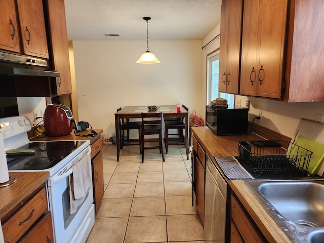 kitchen featuring white electric range oven, a textured ceiling, sink, light tile patterned floors, and decorative light fixtures