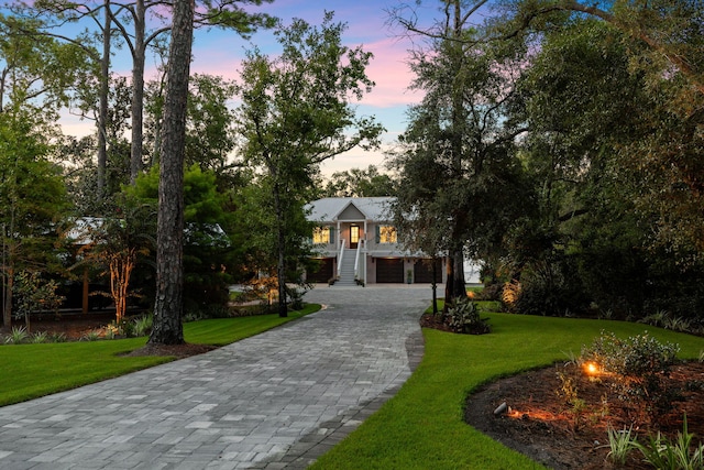 view of front of property with a lawn, a garage, and covered porch