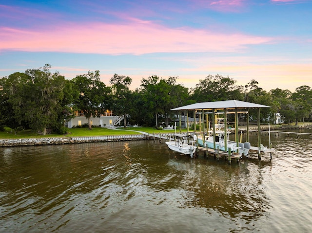 dock area with a lawn and a water view