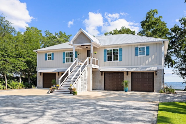 view of front facade featuring a water view and a garage