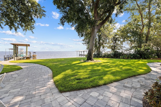 view of yard featuring a boat dock and a water view