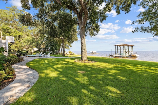 view of yard featuring a water view and a dock