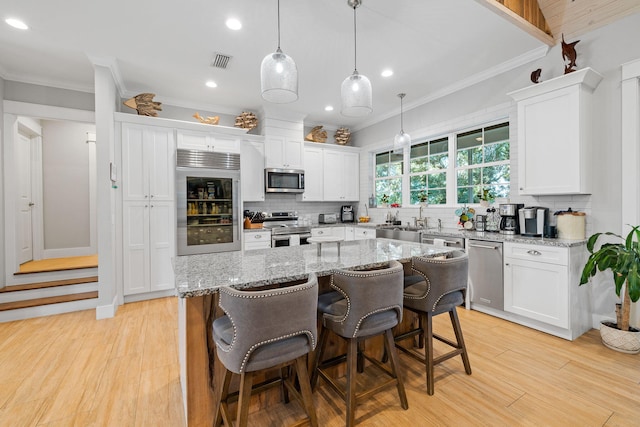 kitchen with a kitchen island, white cabinetry, and stainless steel appliances