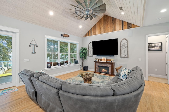 living room with high vaulted ceiling, light hardwood / wood-style flooring, and plenty of natural light