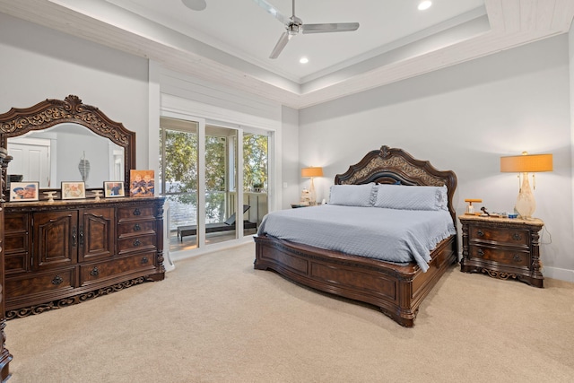 bedroom with a raised ceiling, ceiling fan, light carpet, and access to outside