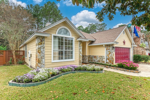 1905 W Mistral Ln, Fort Walton Beach, FL 32547 - view of front of home with stone siding, a garage, concrete driveway, roof with shingles, and a chimney