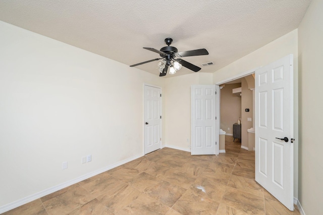1905 W Mistral Ln, Fort Walton Beach, FL 32547 - unfurnished bedroom featuring a textured ceiling and ceiling fan