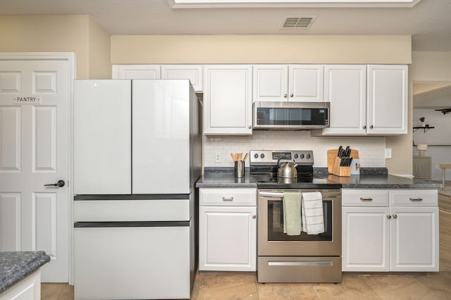 1905 W Mistral Ln, Fort Walton Beach, FL 32547 - kitchen with appliances with stainless steel finishes, white cabinetry, and backsplash