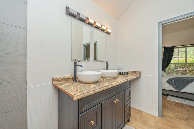 1905 W Mistral Ln, Fort Walton Beach, FL 32547 - ensuite bathroom with double vanity, wainscoting, and lofted ceiling