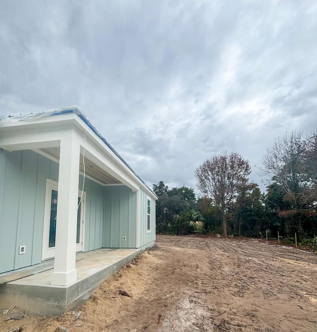 view of side of property with a patio