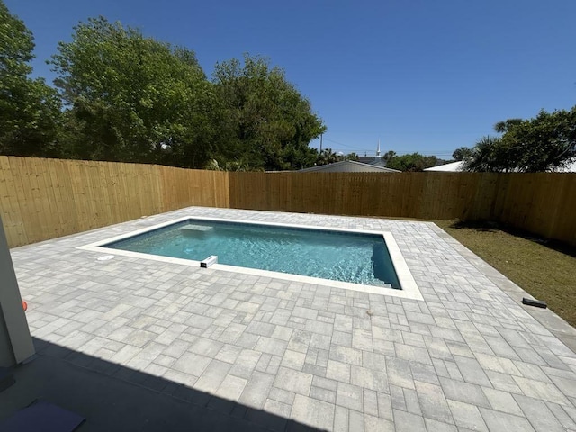 view of swimming pool with a fenced in pool, a fenced backyard, and a patio area