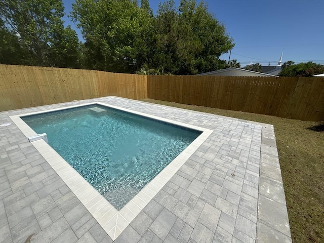 view of pool featuring a fenced backyard, a fenced in pool, and a patio area