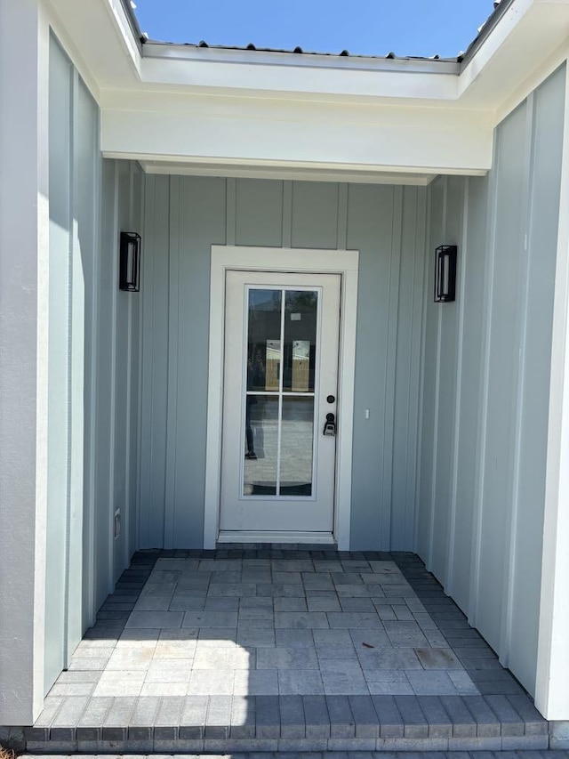 doorway to property featuring board and batten siding