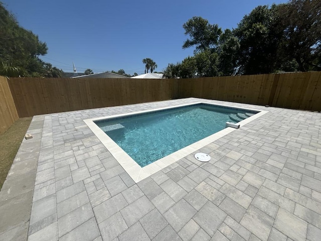 view of pool with a fenced backyard, a fenced in pool, and a patio area