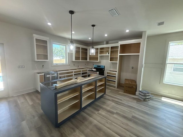 kitchen featuring open shelves, visible vents, and stainless steel range oven
