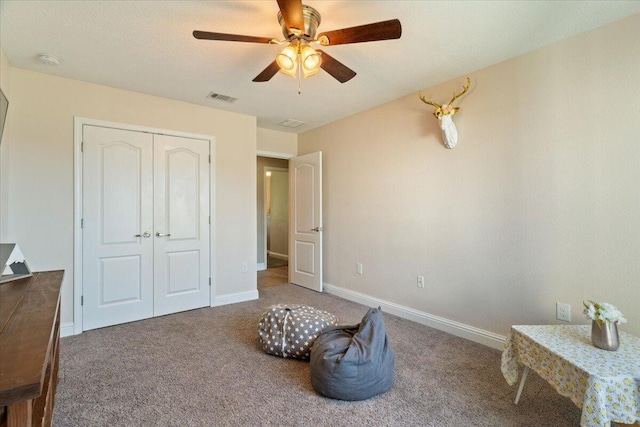 bedroom featuring ceiling fan, carpet floors, and a closet