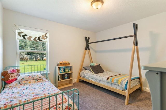 bedroom featuring a textured ceiling and carpet floors