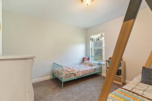 carpeted bedroom with a textured ceiling