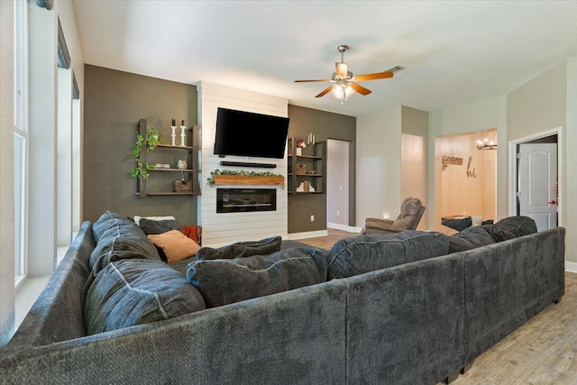 living room featuring ceiling fan and light hardwood / wood-style floors