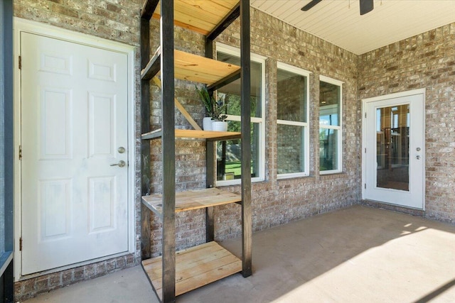 property entrance with a patio area and ceiling fan