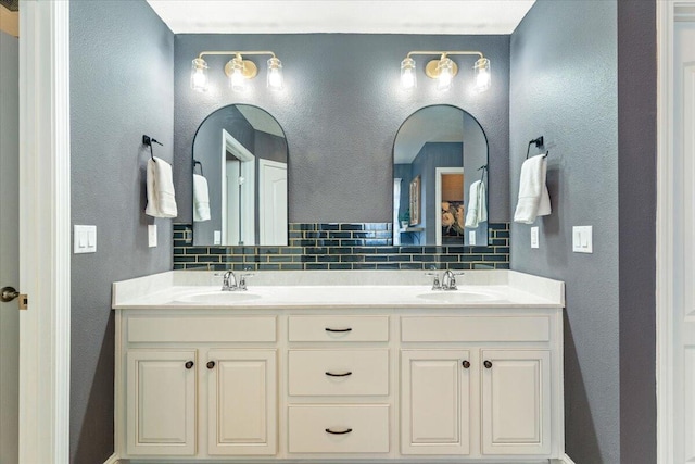 bathroom featuring tasteful backsplash and vanity