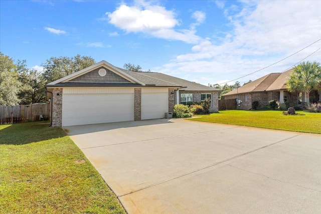 single story home with a garage and a front lawn