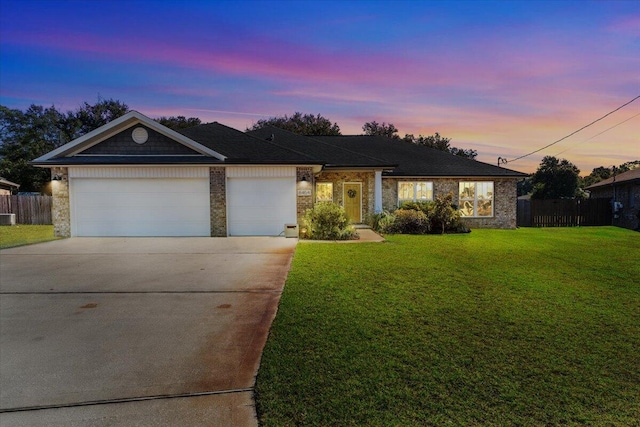 single story home with a yard and a garage